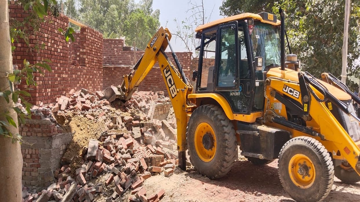 Bulldozers run on the madrasa being built illegally in Budaun