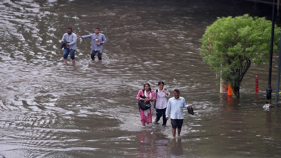pictures of Heavy Rain In Delhi Roads Flooded Car Submerged Traffic Crawls