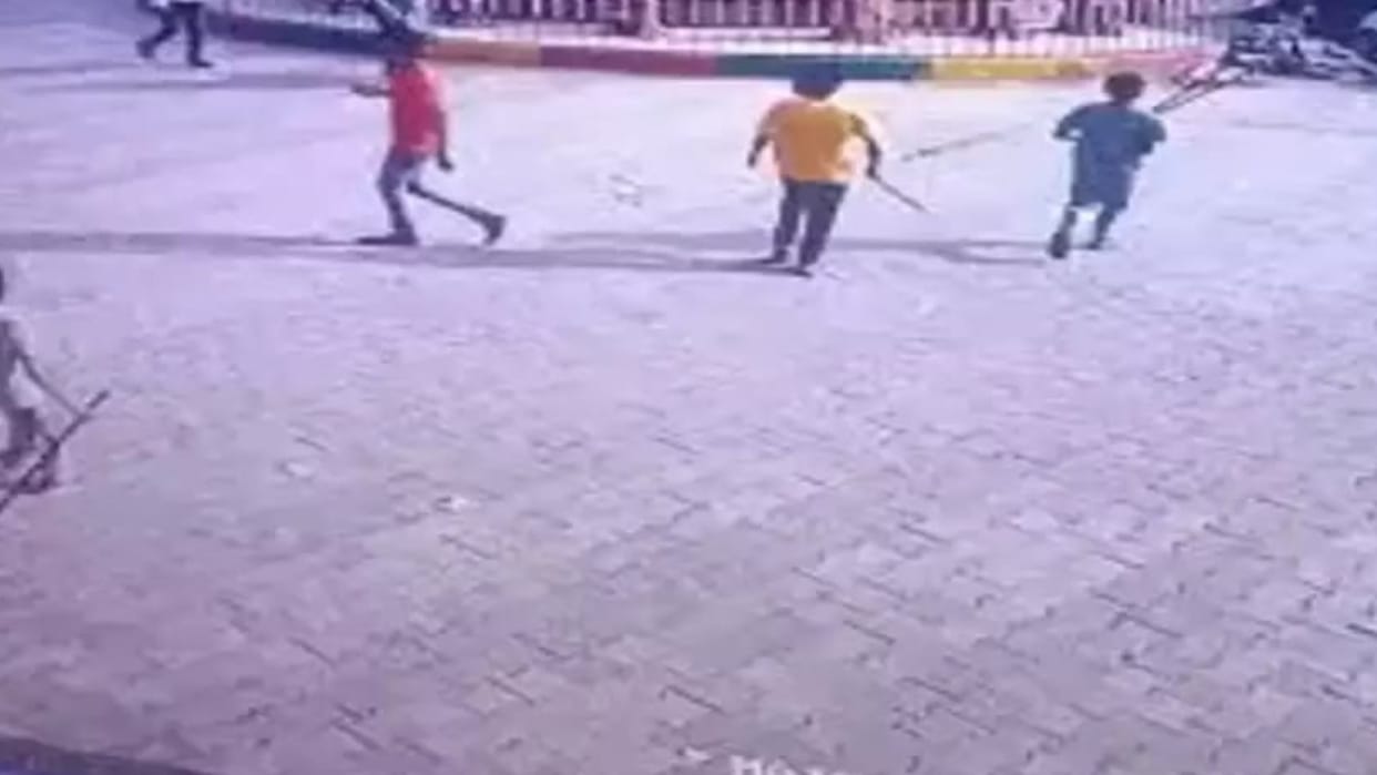 A young man sitting at a shop was attacked with sticks