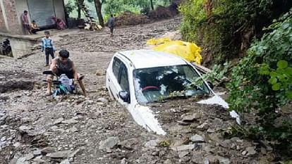 Drain flooded due to torrential rains, cars and bikes buried under debris