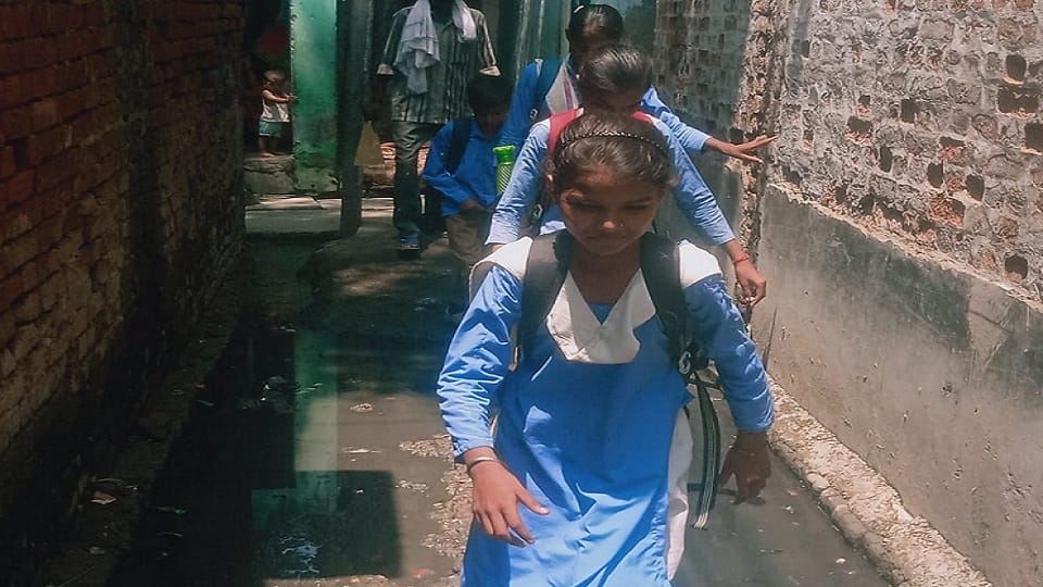 School children have to cross dirty water