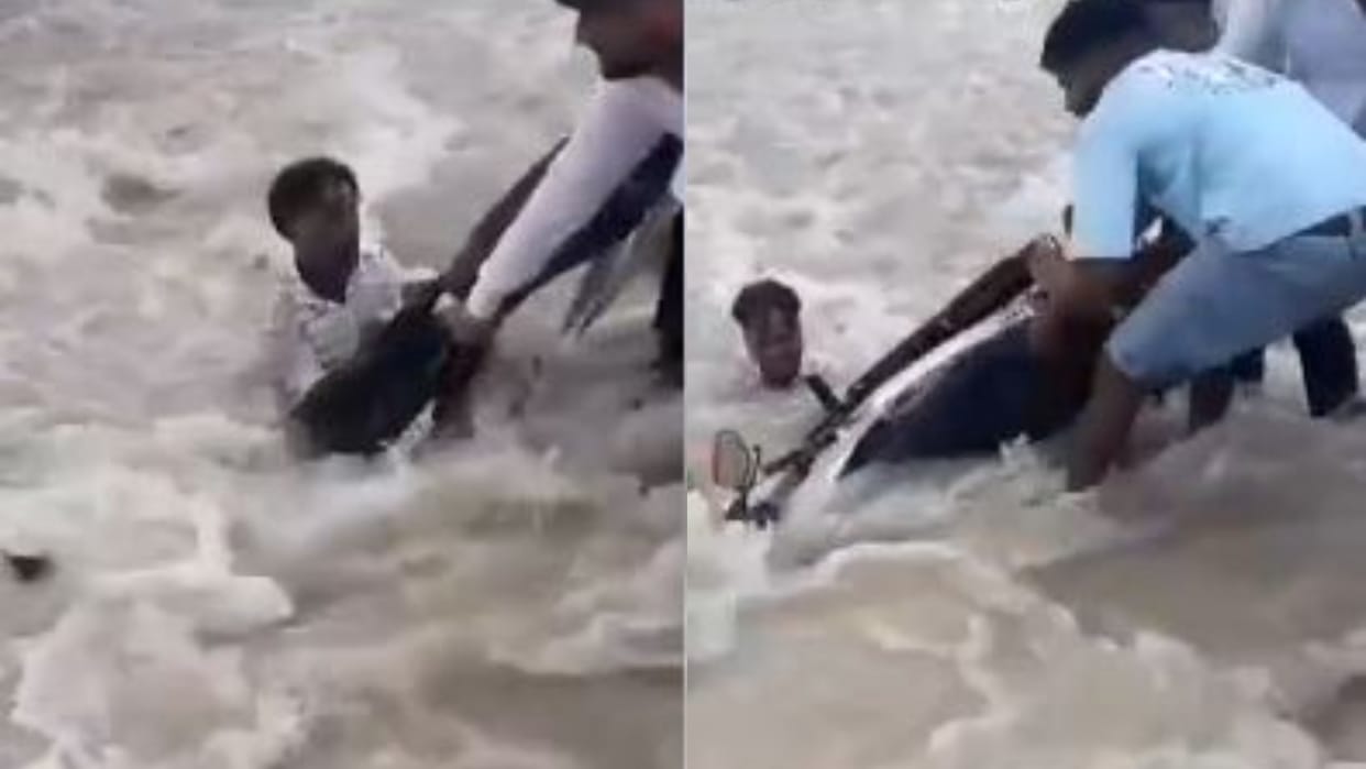 man was swept away along with his bike in flood waters people saved his life in lakhimpur kheri