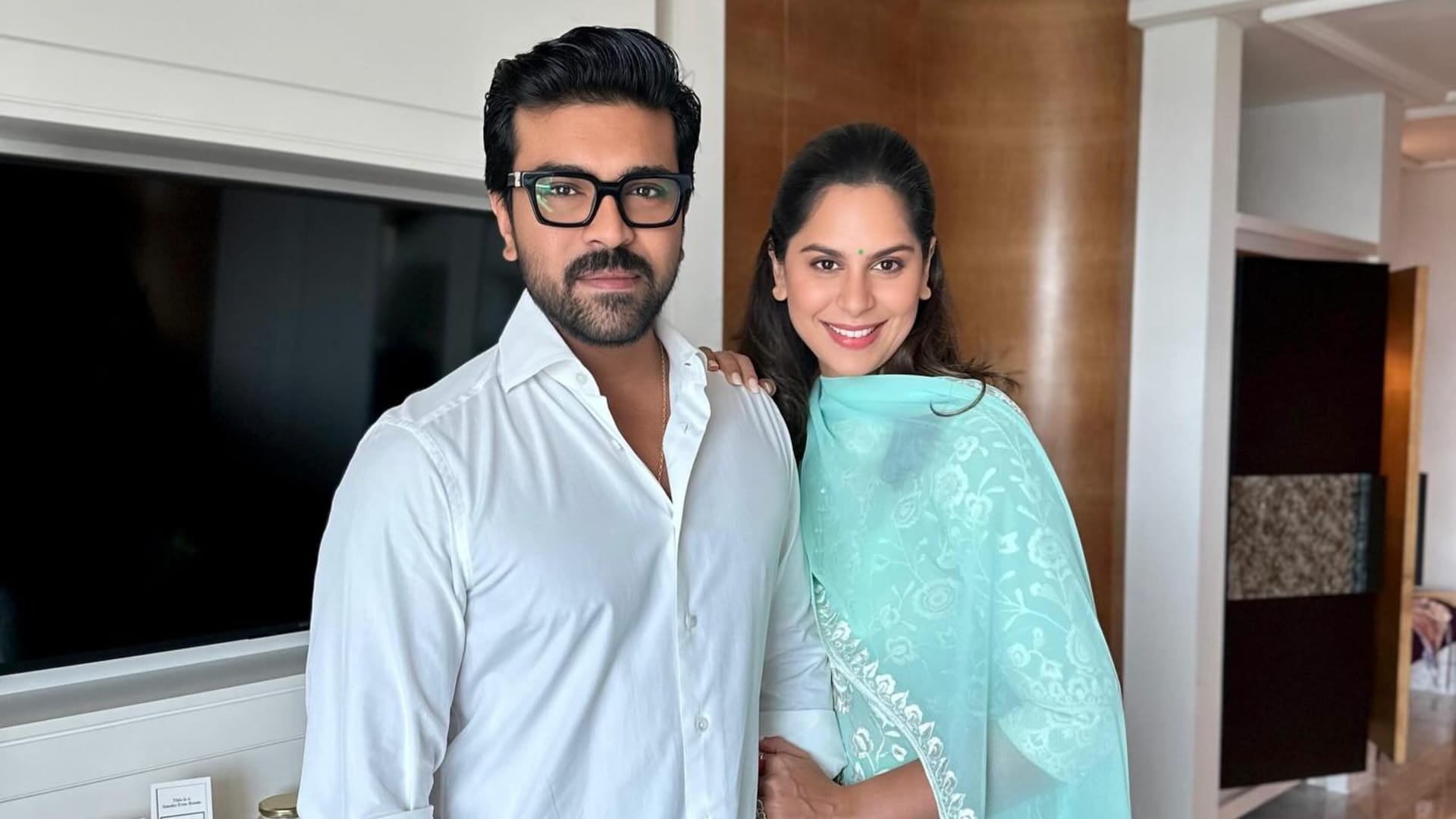 Ram Charan Peddi crosses 100 crore worldwide Upasana Konidela celebrates with fireworks and cake Watch video