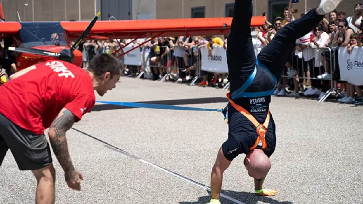 Italian man pulls three planes while walking on his hands in remarkable feat of strength