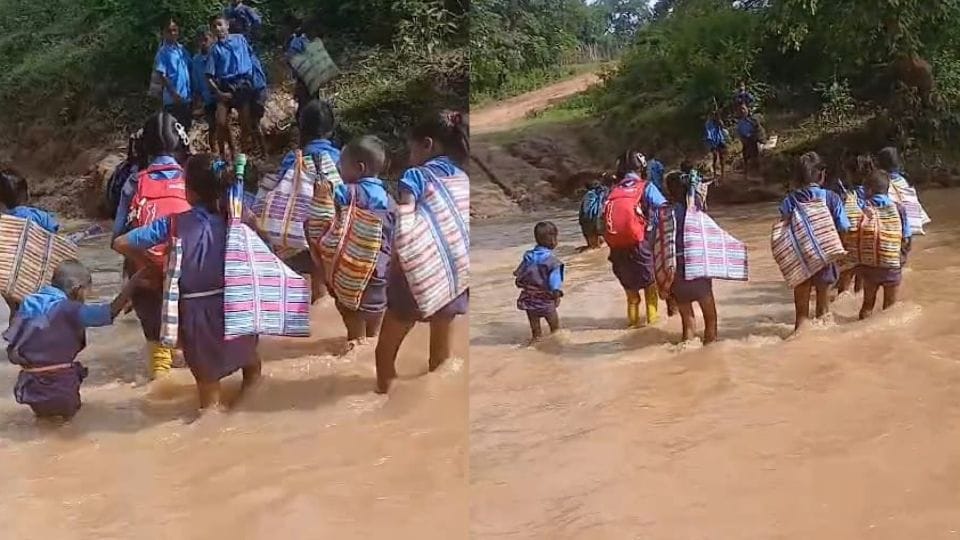 Children crossing swollen river in Kondgaon to reach school