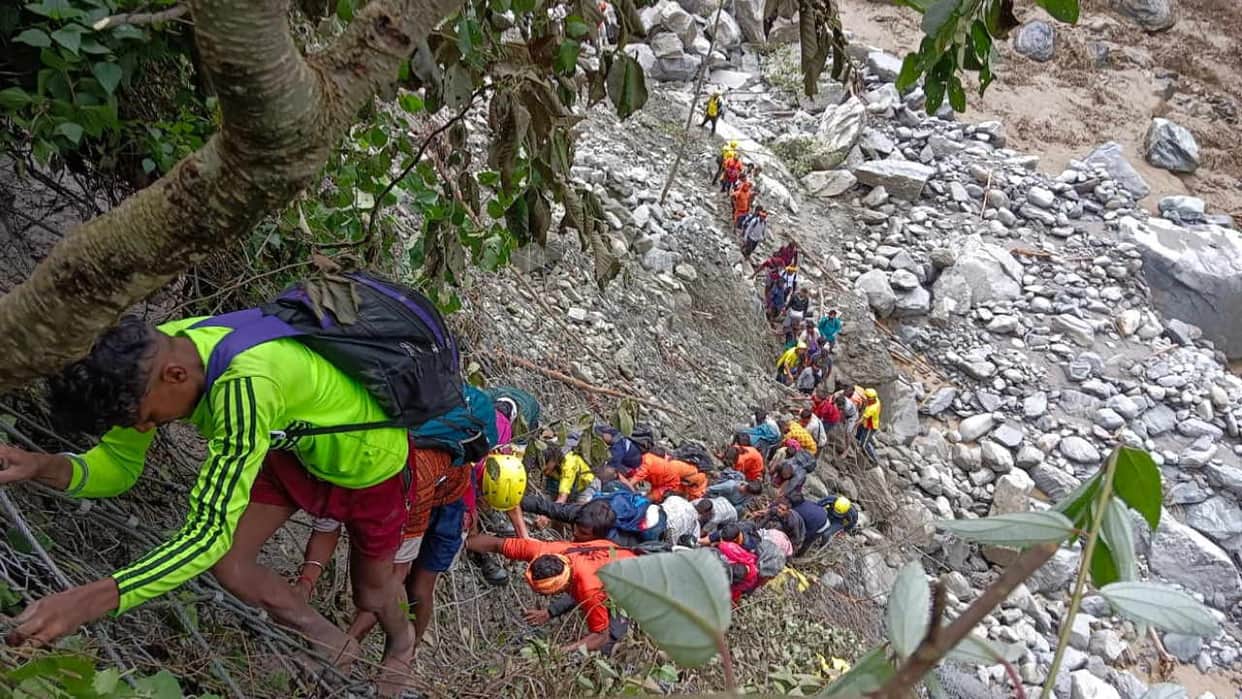 Kedarnath rescue Soldiers bringing people down from a steep cliff with the help of a rope Watch Photos