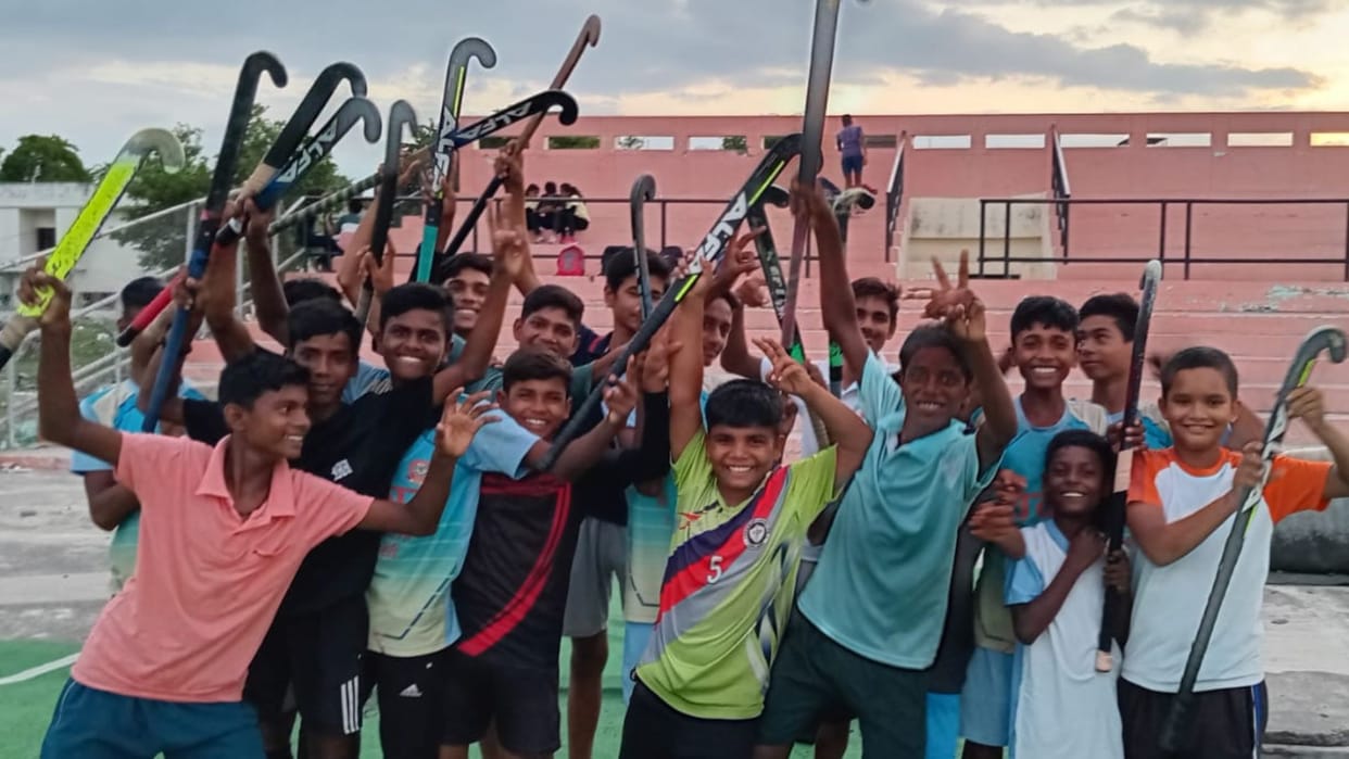 olympic Seniors saluted waving sticks sports will lead to physical mental and spiritual development