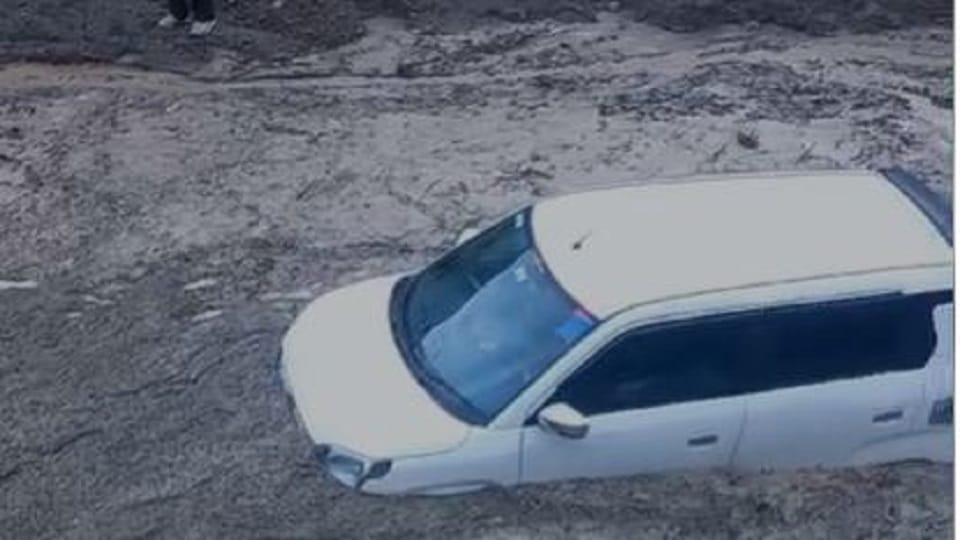 Car stuck in debris near Netala on Gangotri Highway