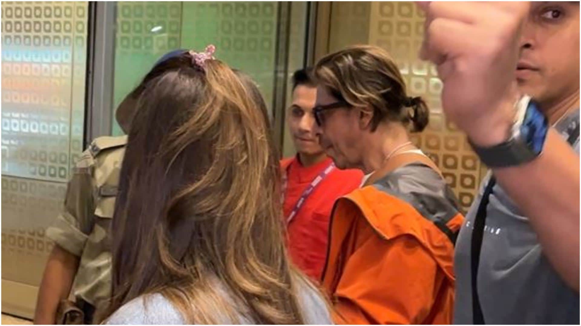 Shah Rukh Khan Spotted at Airport in stunning look wearing orange jacket actor left for Switzerland