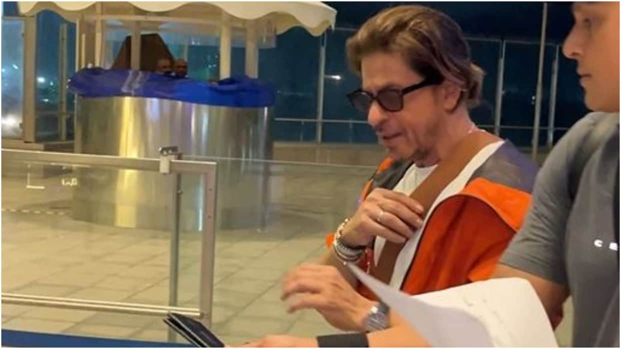 Shah Rukh Khan Spotted at Airport in stunning look wearing orange jacket actor left for Switzerland