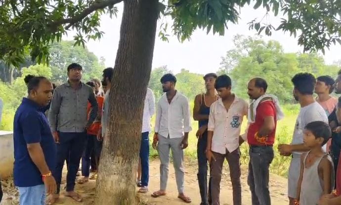 Dead body of a young man found lying under a tree in the field