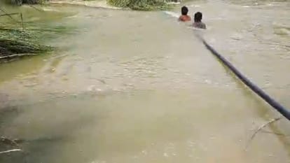 village of UP facing brunt of floods in mau people crossing the river help of pipes lack of facilities exposed