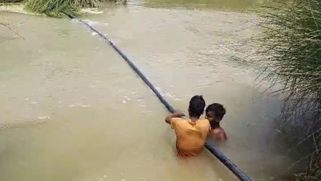 village of UP facing brunt of floods in mau people crossing the river help of pipes lack of facilities exposed