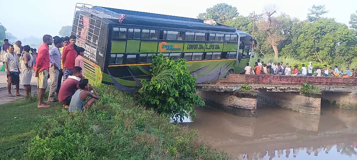 A bus hanged from a bridge in Khairighat thana in Bahraich.