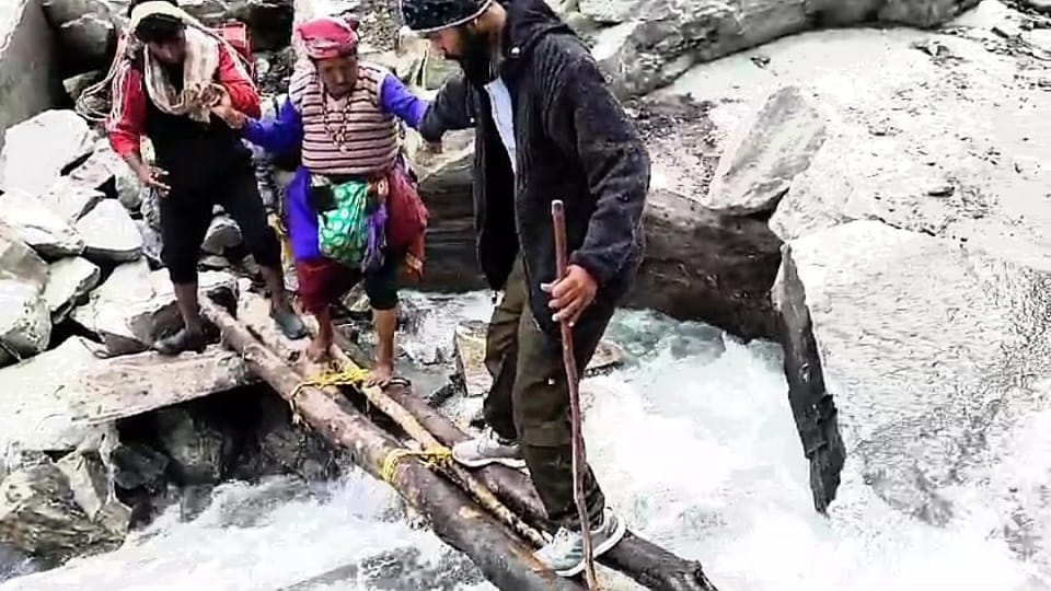 People crossing the river with the help of wooden logs in pithoragarh