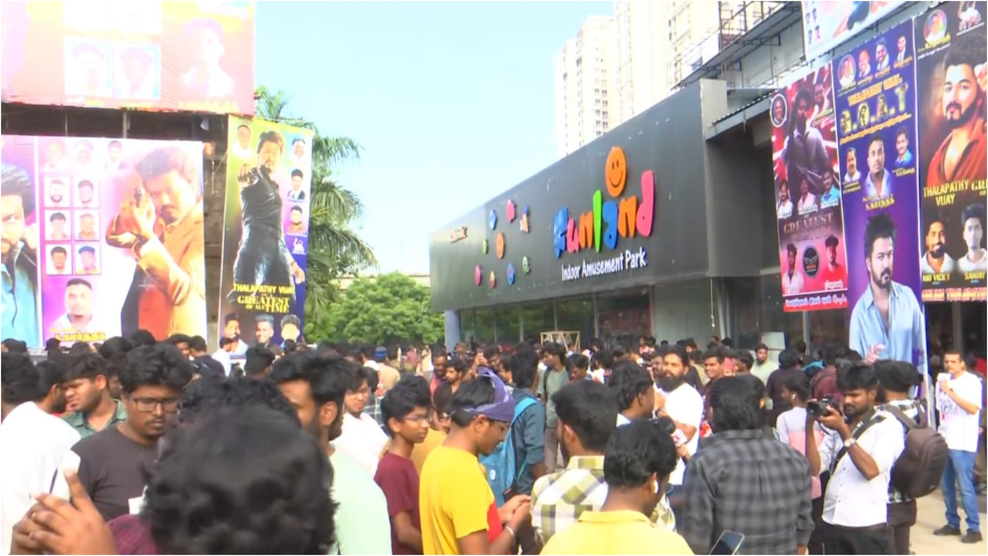 Thalapathy Vijay fans celebrate his movie the GOAT release dancing outside theaters pour milk on posters
