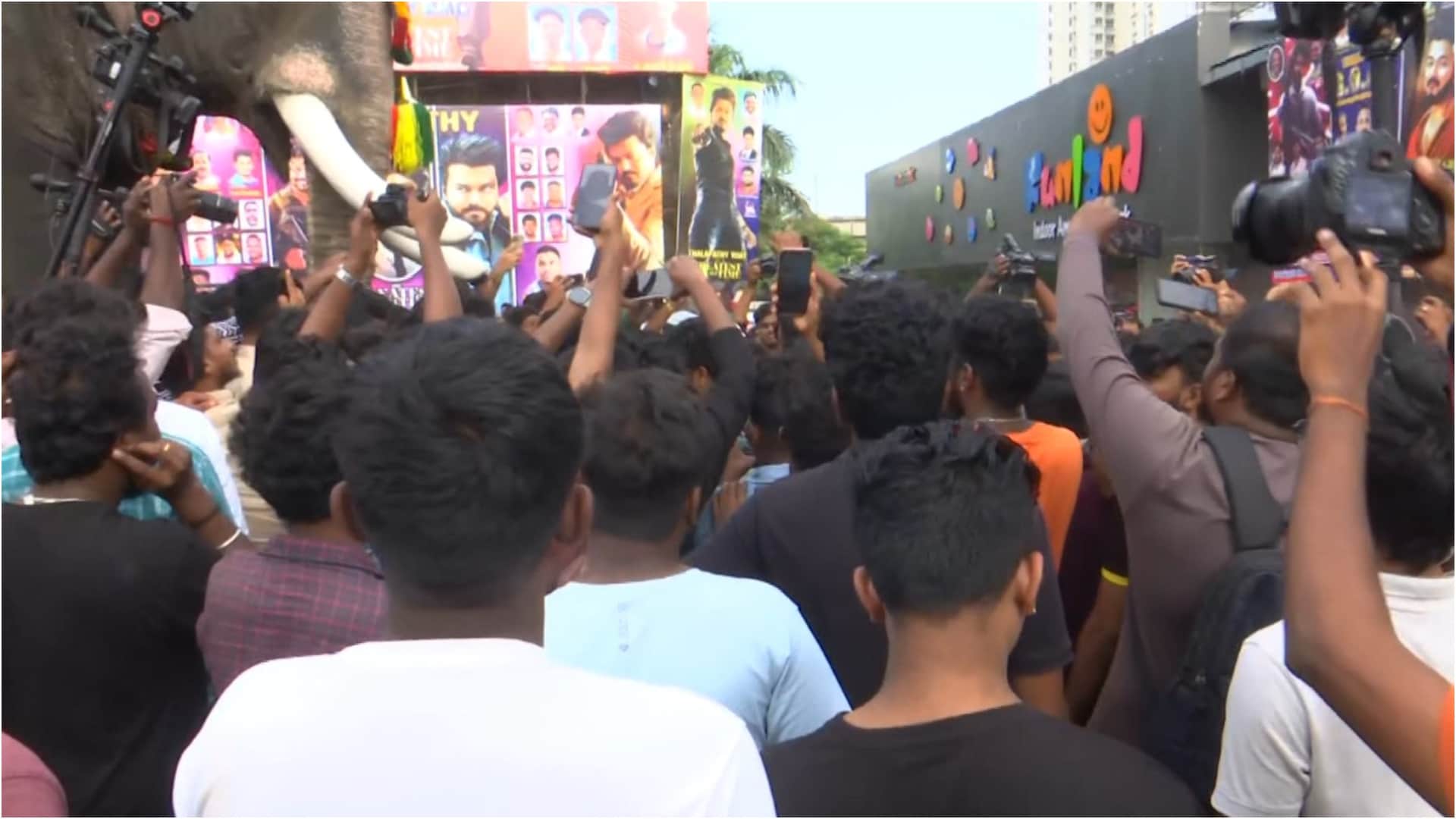 Thalapathy Vijay fans celebrate his movie the GOAT release dancing outside theaters pour milk on posters
