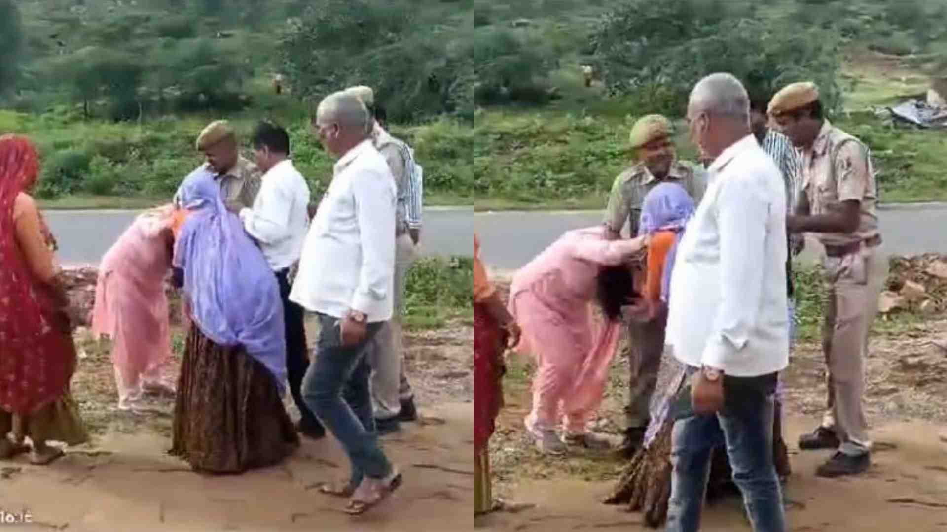 एसडीएम से उलझी महिला को हटाते पुलिस कर्मी।