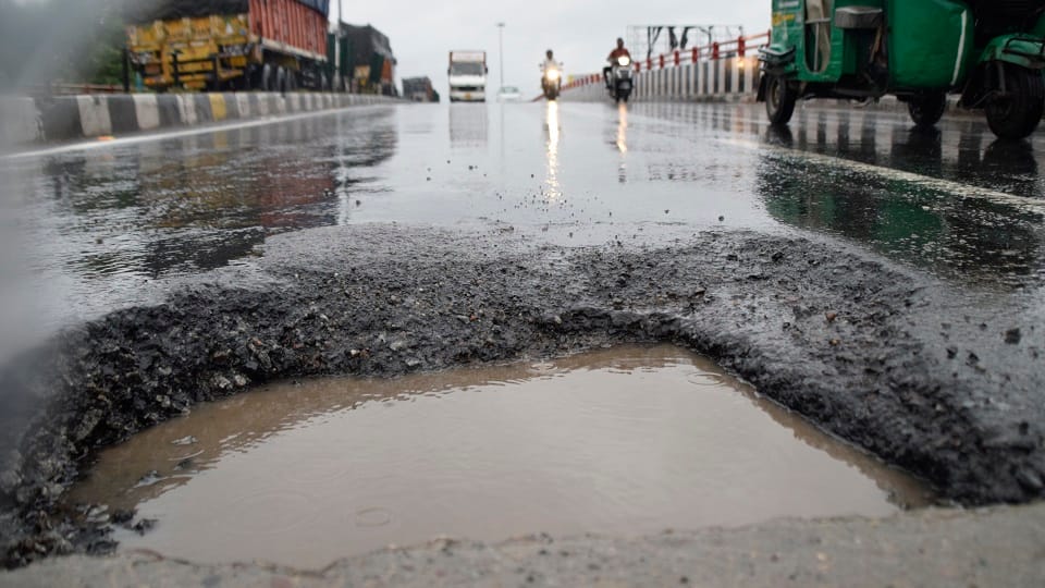 Rain exposed many one foot potholes on the highway, increased risk of accident