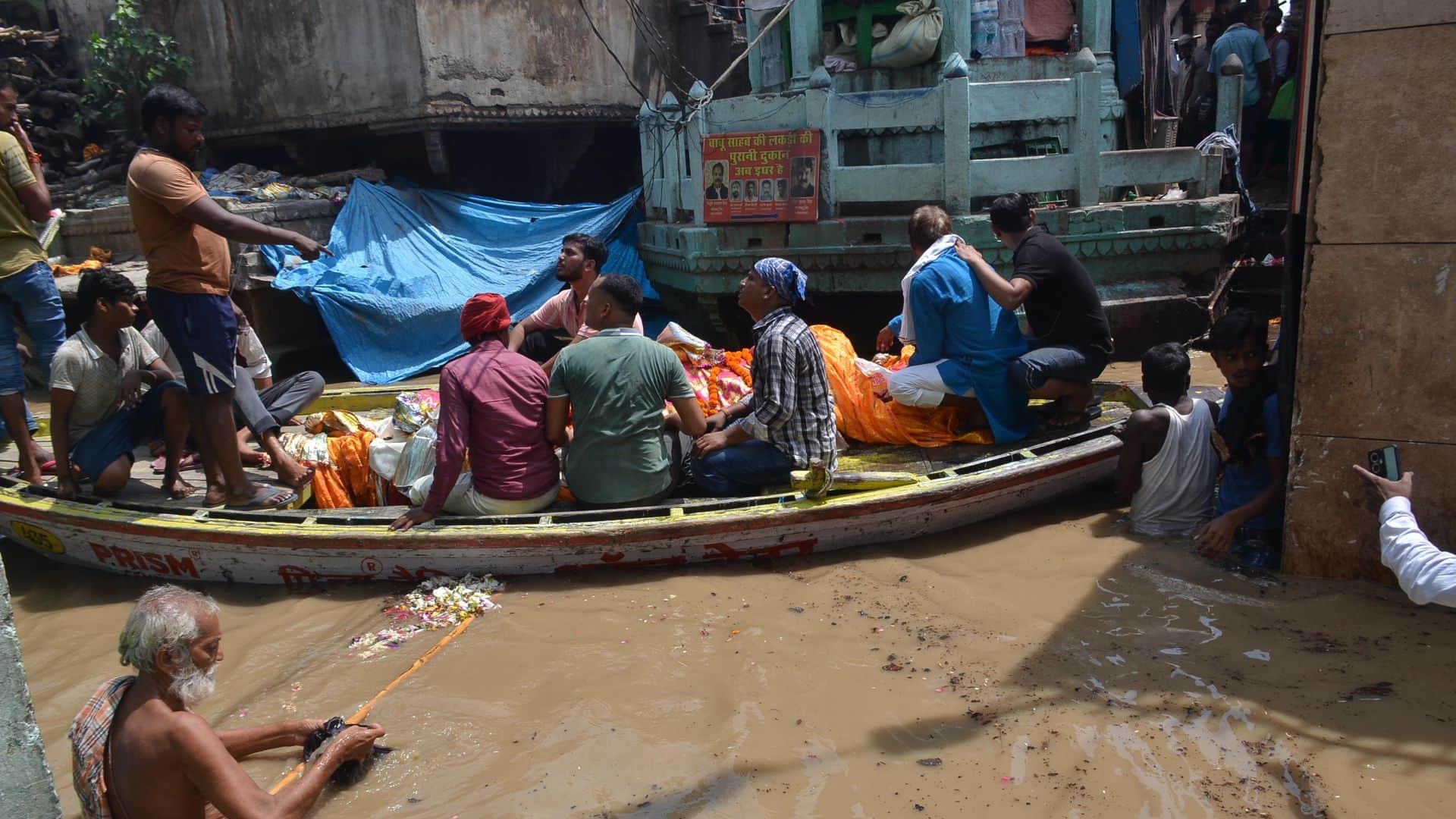Flood in varanasi Boats in streets of Manikarnika Ganga flowing on road