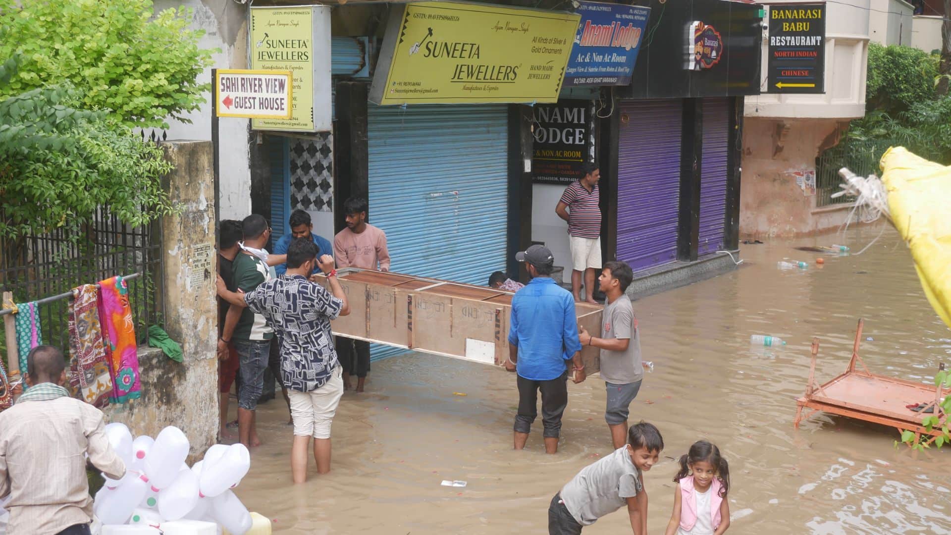 Flood in varanasi Boats in streets of Manikarnika Ganga flowing on road