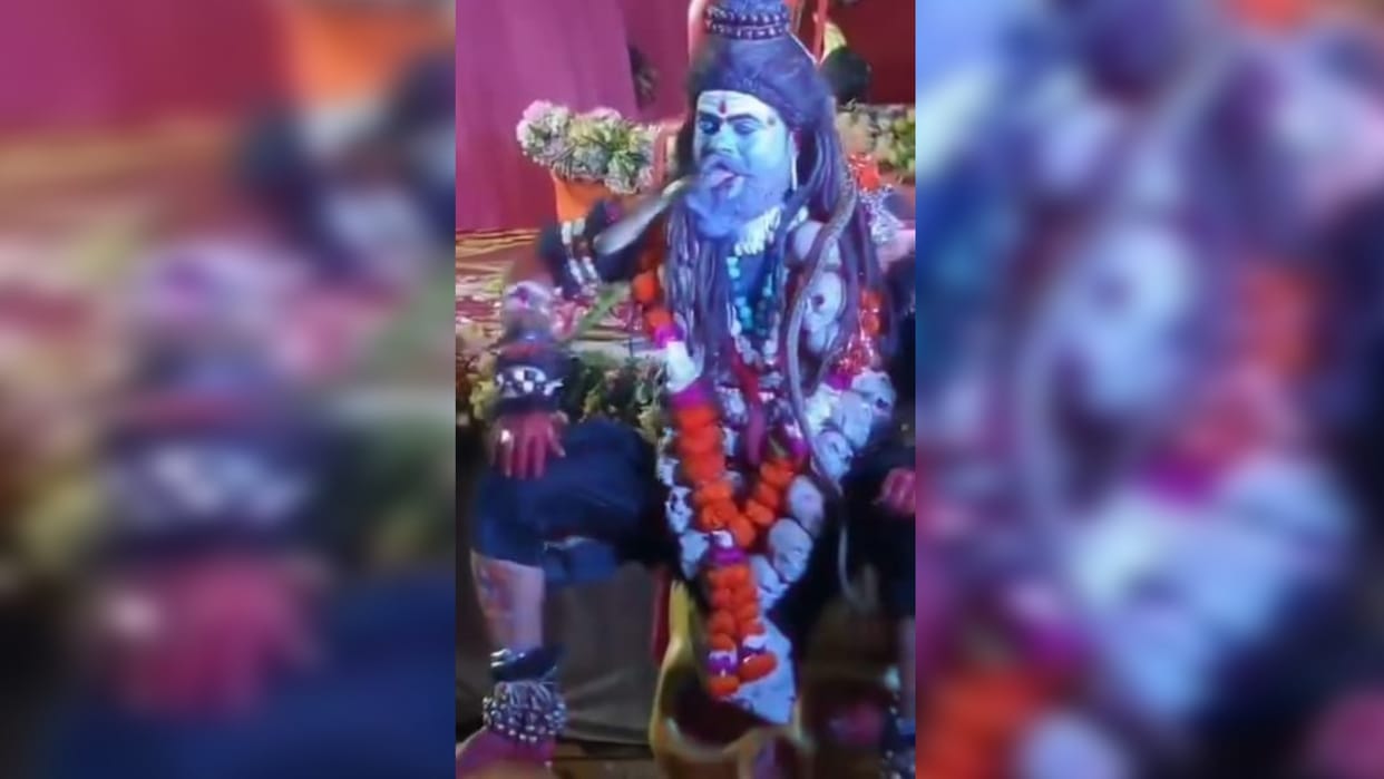 Playing with snakes in Ganesh festival tableaus in Shivpuri