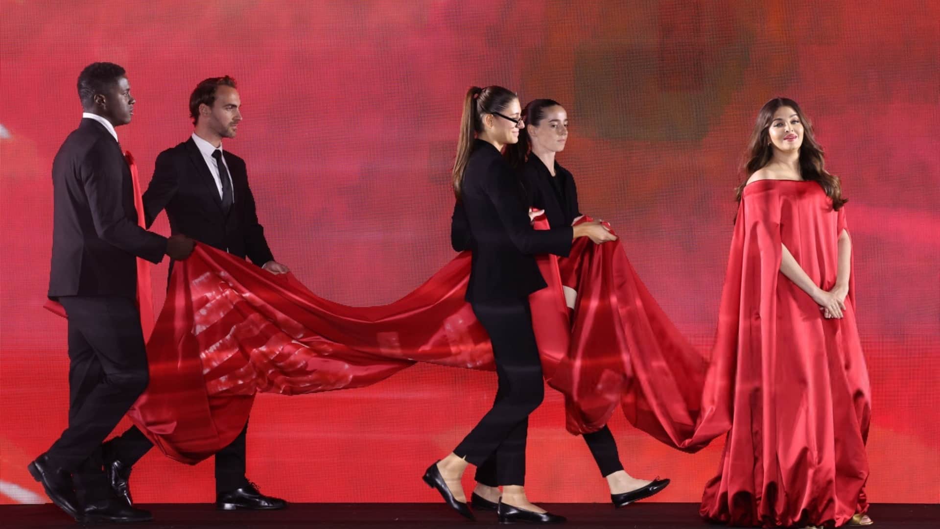 Aishwarya Rai Bachchan donned a red balloon hem dress with a dramatic train at Paris Fashion week