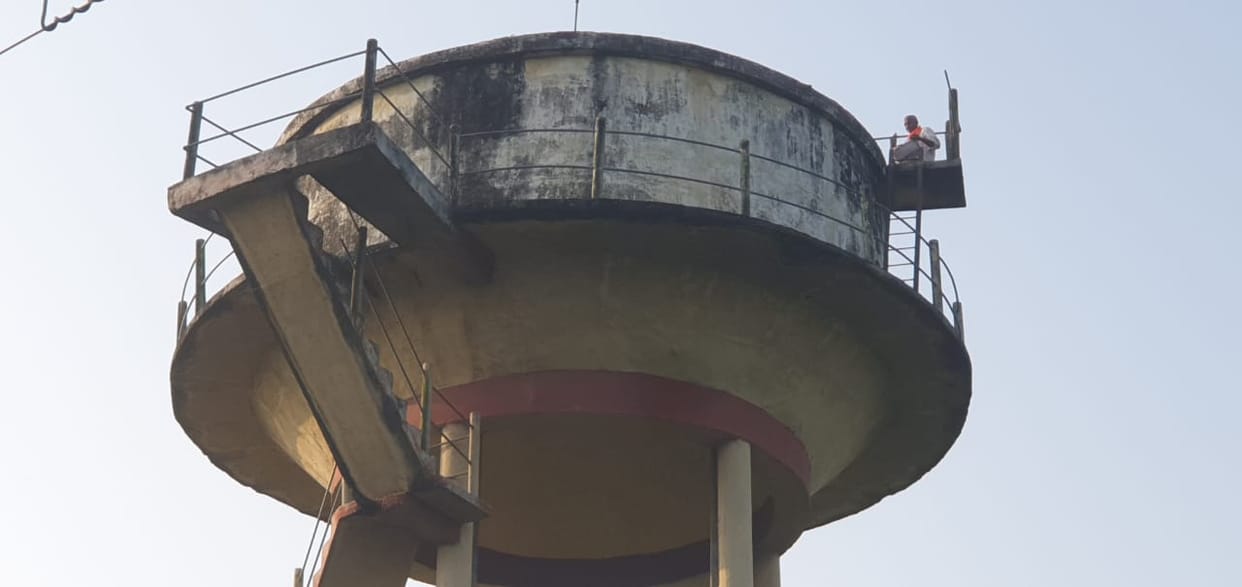 A cleaner climbed on a water tank in karnailganj in Gonda.