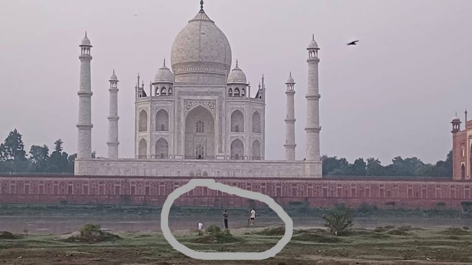 Three tourists reached Yamuna riverbed behind Taj Mahal with tripods and cameras
