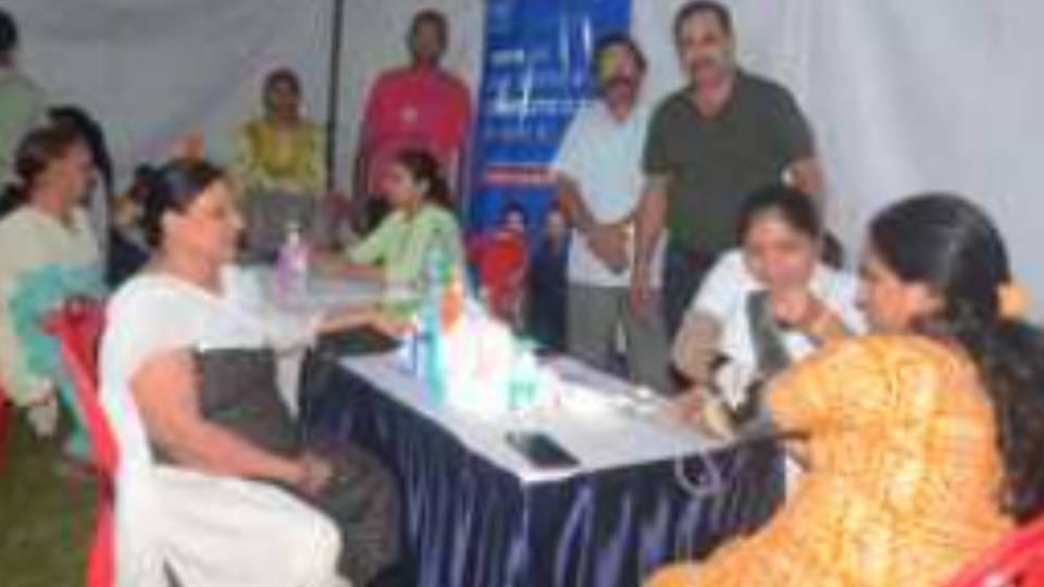 doctor examined and advised patients suffering from viral fever muscle pain and cough In health camp