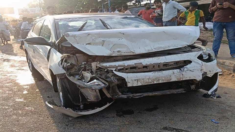 Car damaged after colliding with tractor-trolley