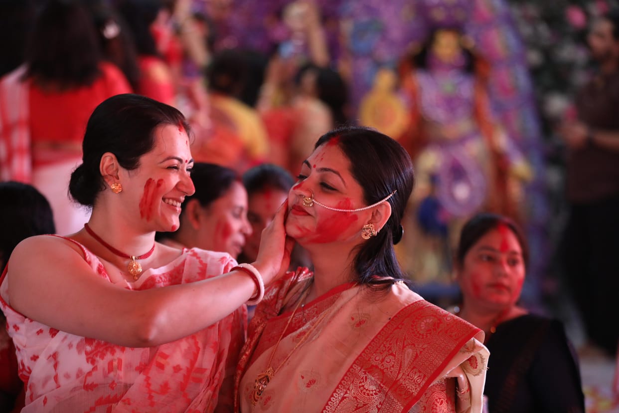 Women play sindoor on the day of Durga idols immersion in Lucknow.