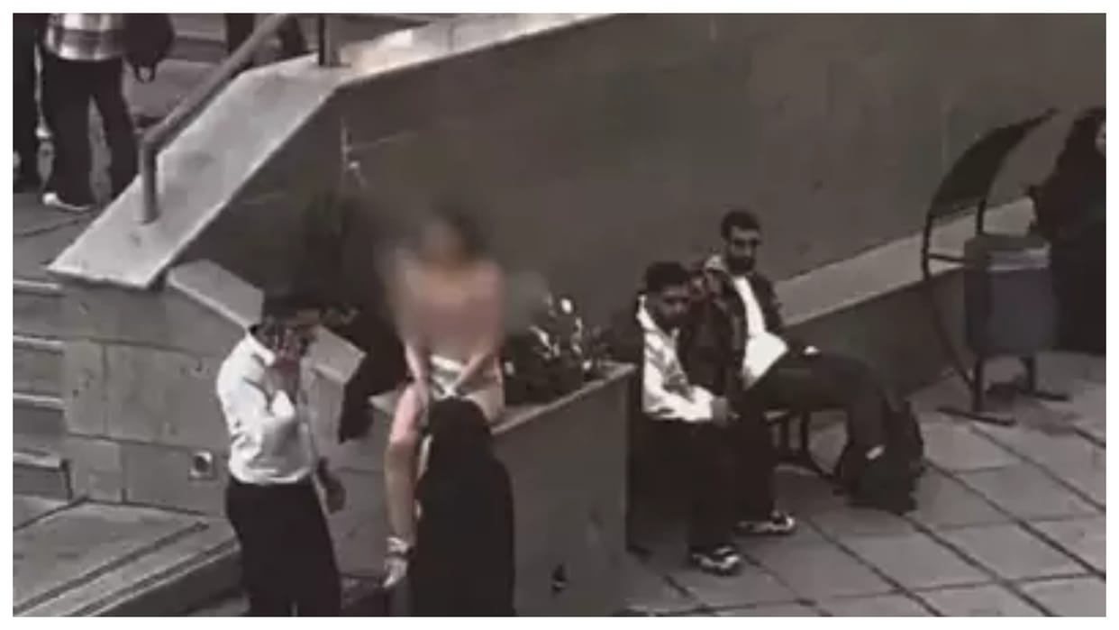 iran woman strips in public over assault by security forces for imposing hijab