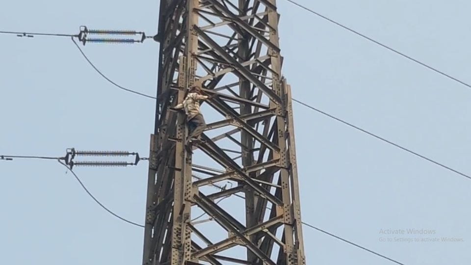 person climbed an electric high tension pole in Noida Sector-76