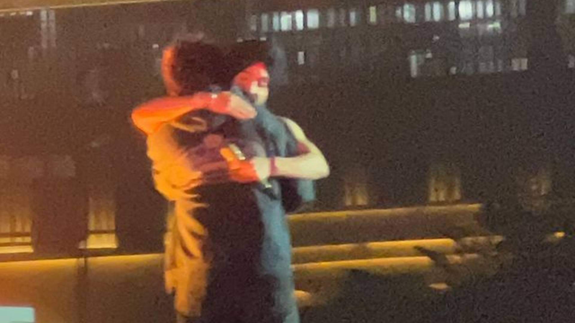 Diljit Dosanjh and Kartik Aaryan raising their hands as they twinned in black outfits at Ahmedabad show