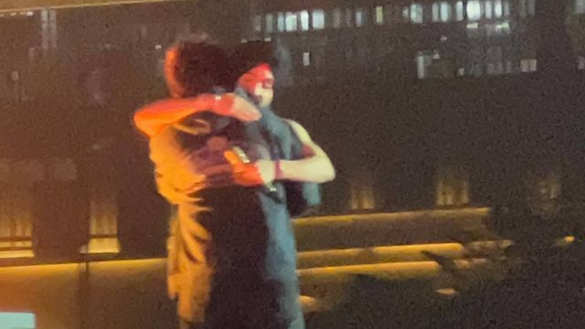 Diljit Dosanjh and Kartik Aaryan raising their hands as they twinned in black outfits at Ahmedabad show