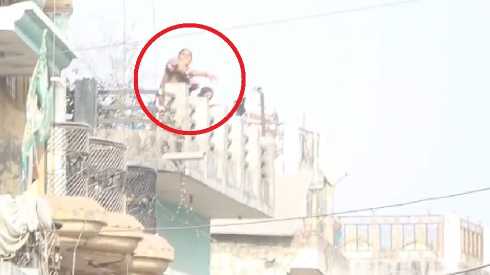 New video of Sambhal violence Woman and child seen pelting stones at police from rooftop