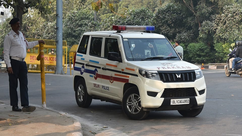 A truck loaded with gravel overturned after a road caved in, crushing a passing woman to death