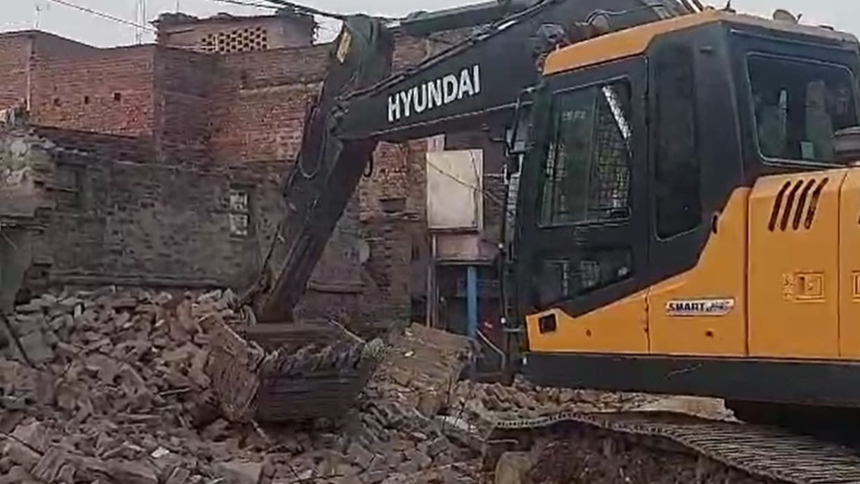 The havoc of cruel bulldozer; while demolishing a house debris fell on another house,