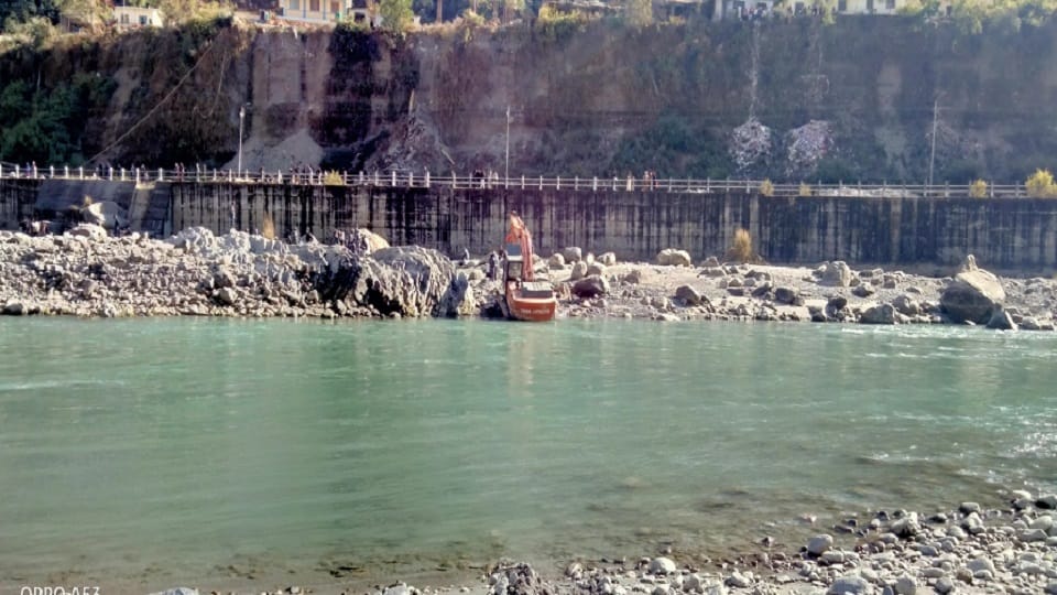 people. Nepal. operator. JCB engaged. embankment.