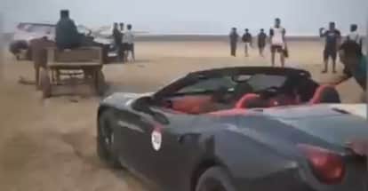 Ferrari luxury car stuck on sand