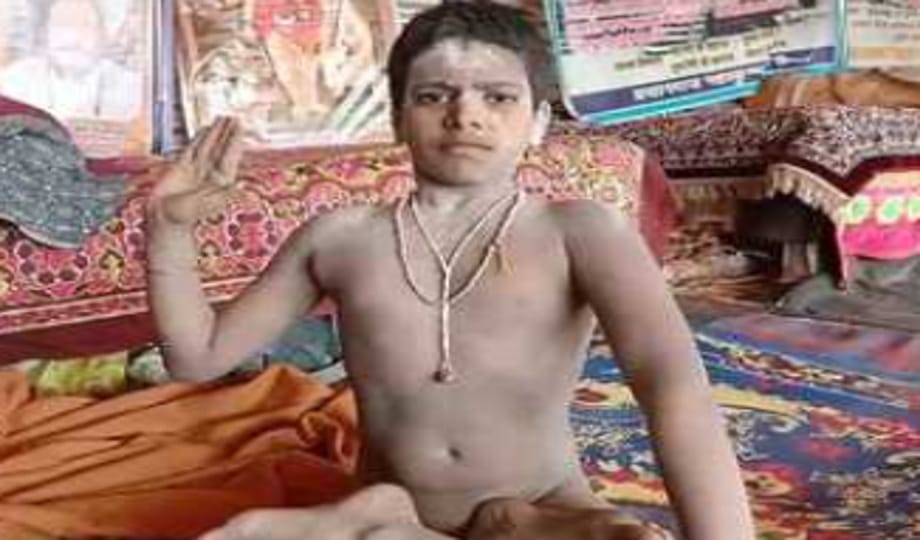 Nine-year-old Naga sanyasi Gopal Giri engaged in devotion to Mahadev with ashes on his body