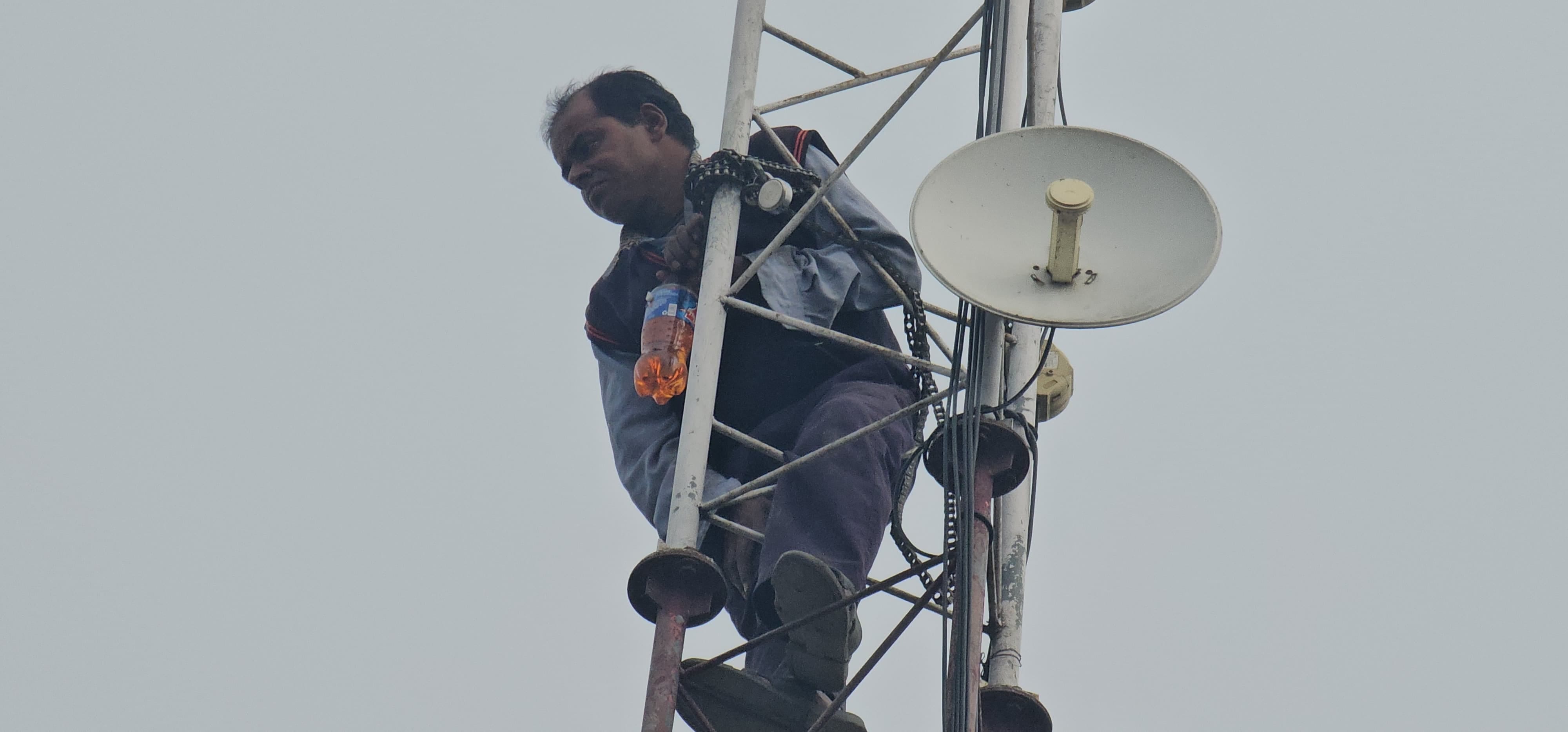Rishikesh News Shopkeeper climbed on mobile tower with bottle of petrol crowd gathered, photos