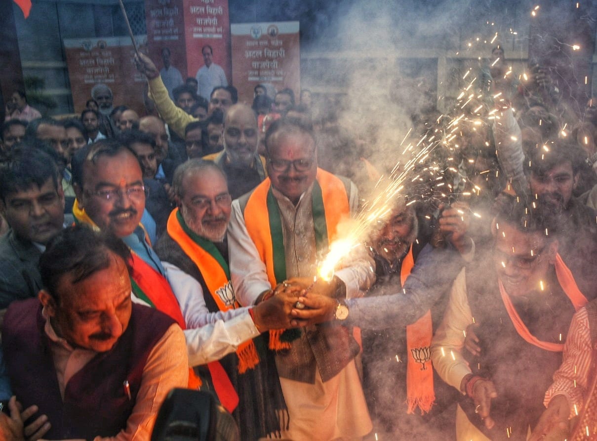 BJP activists celebrate victory in Delhi and Milkipur assembly seat.