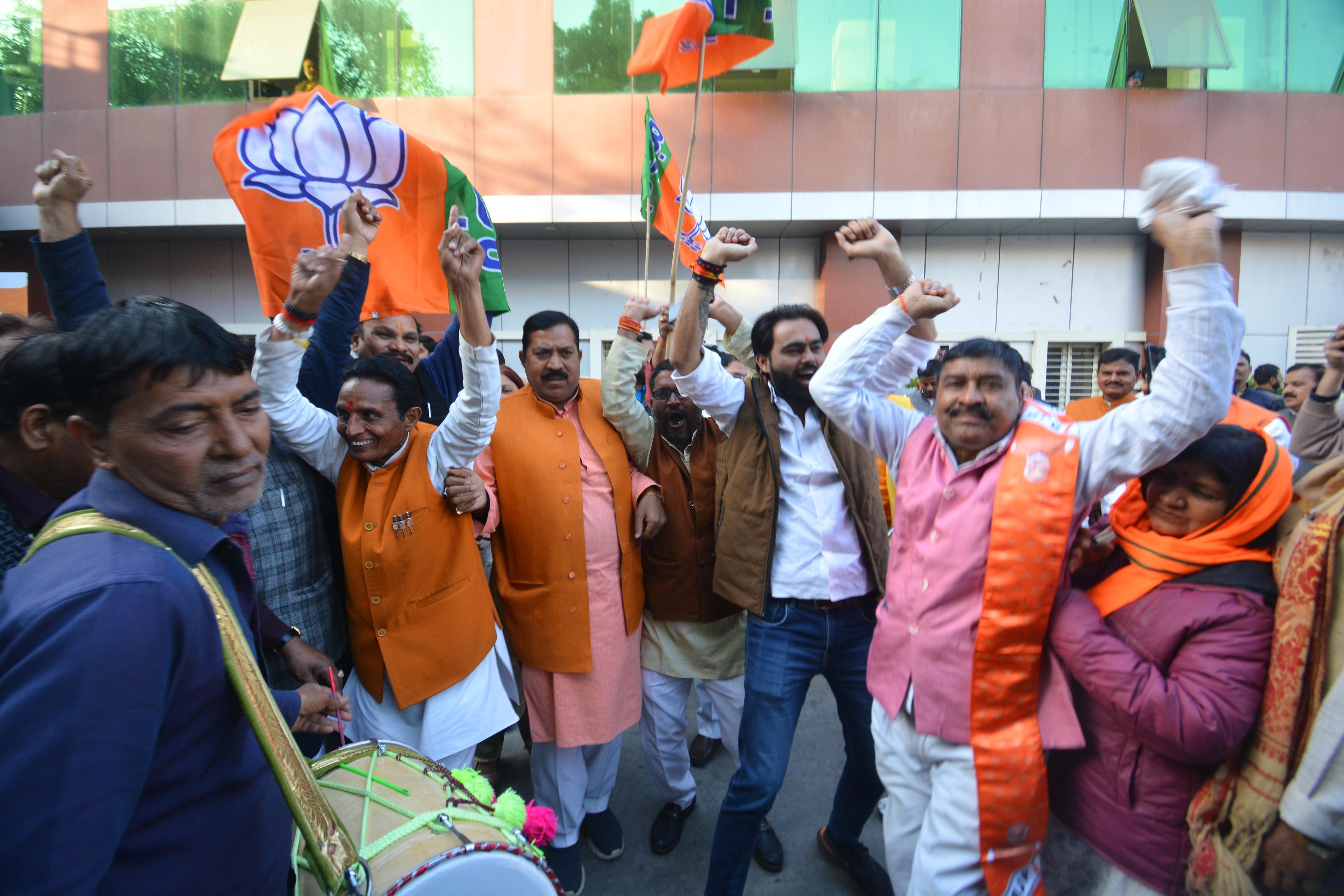 BJP activists celebrate victory in Delhi and Milkipur assembly seat.