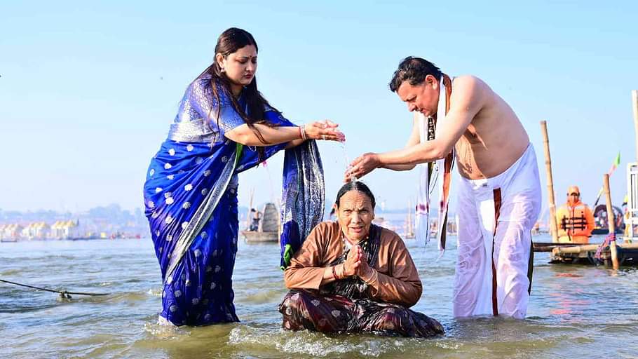 CM Dhami took a dip at Triveni Sangam in Prayagraj Maha Kumbh made his mother take a bath Watch Photos