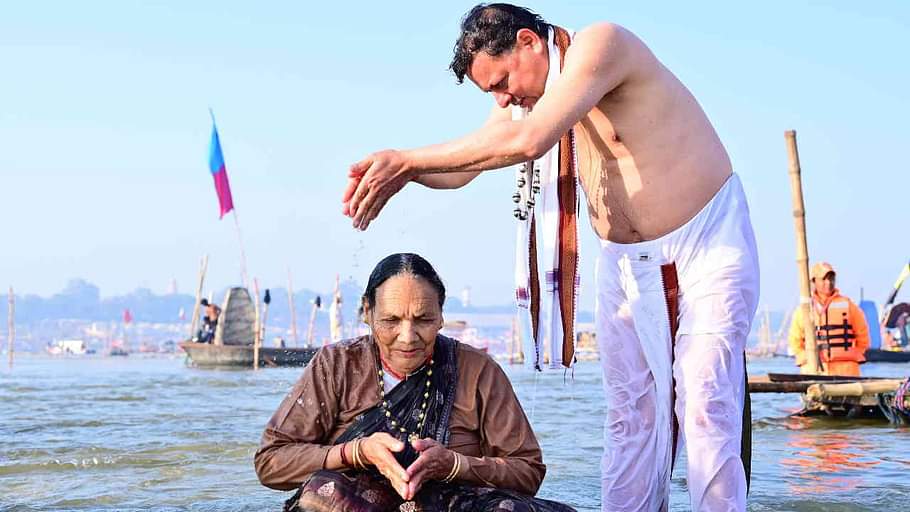 CM Dhami took a dip at Triveni Sangam in Prayagraj Maha Kumbh made his mother take a bath Watch Photos