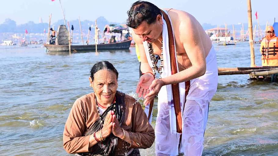 CM Dhami took a dip at Triveni Sangam in Prayagraj Maha Kumbh made his mother take a bath Watch Photos