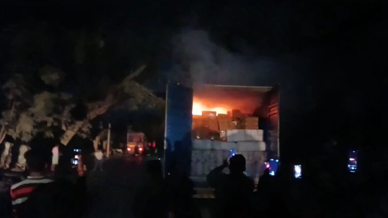 In an attempt to avoid the jam the container came in contact with the high tension wire and caught fire