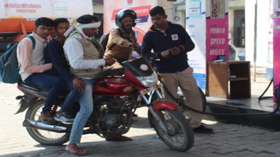 Vehicles are being driven without helmets, getting petrol